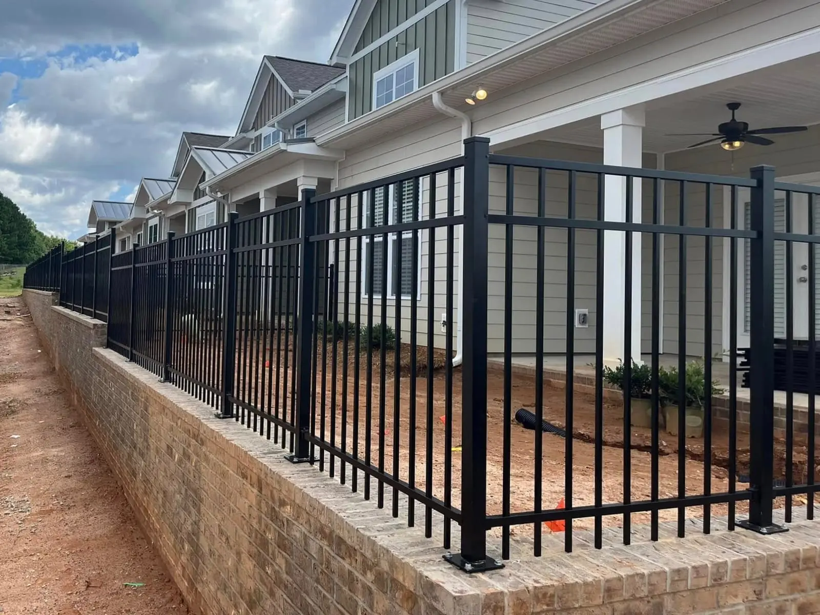 Aluminum fence on a brick knee wall installed by Spartan Fence SC in Roebuck, SC