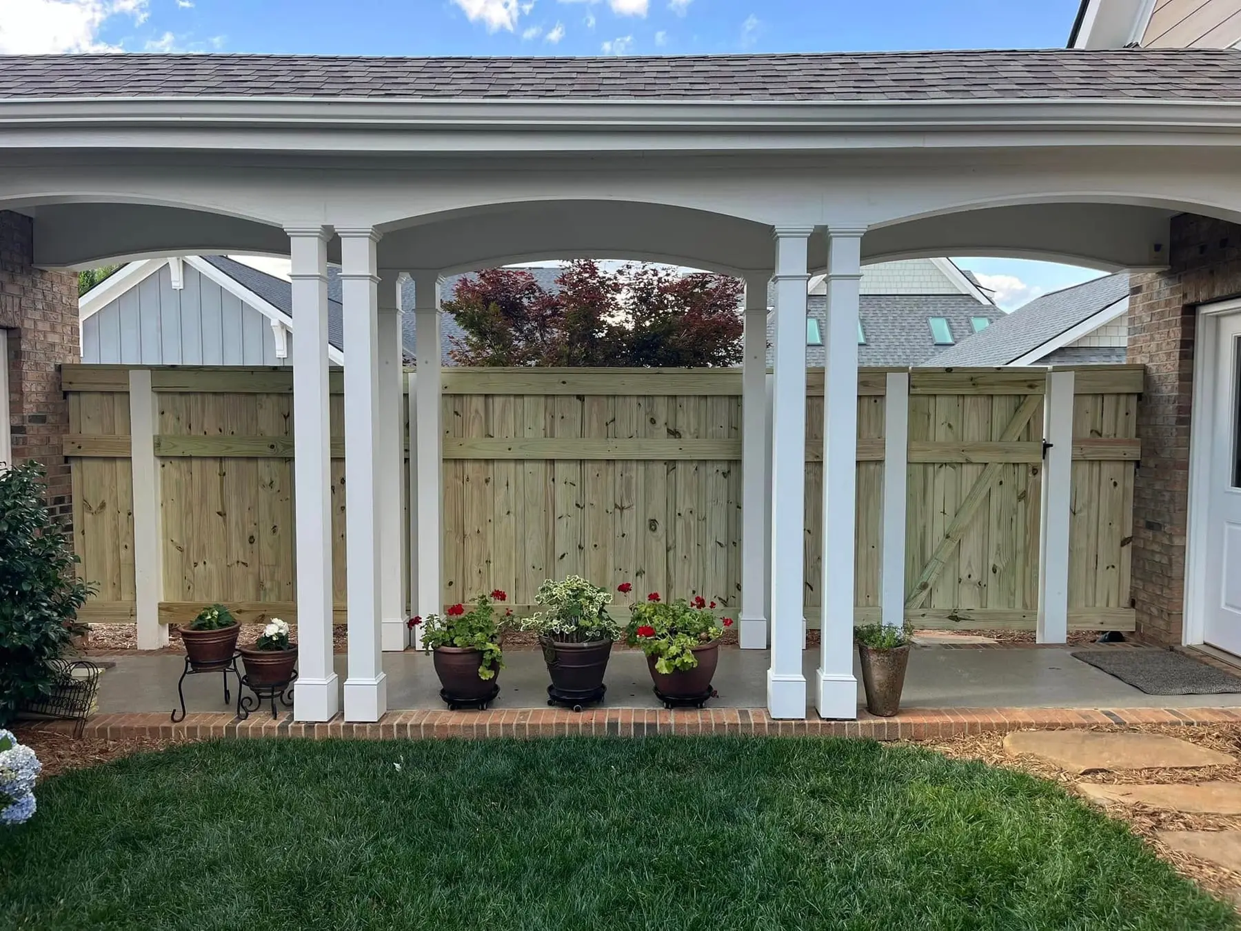 Wood privacy fence under an arched entry built by Spartan Fence SC in Greenville, SC