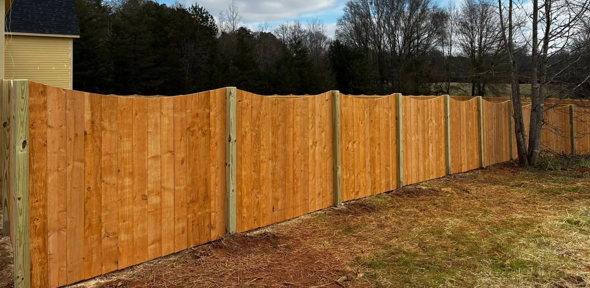 Long scalloped wood privacy fence built by Spartan Fence SC in the Upstate of South Carolina