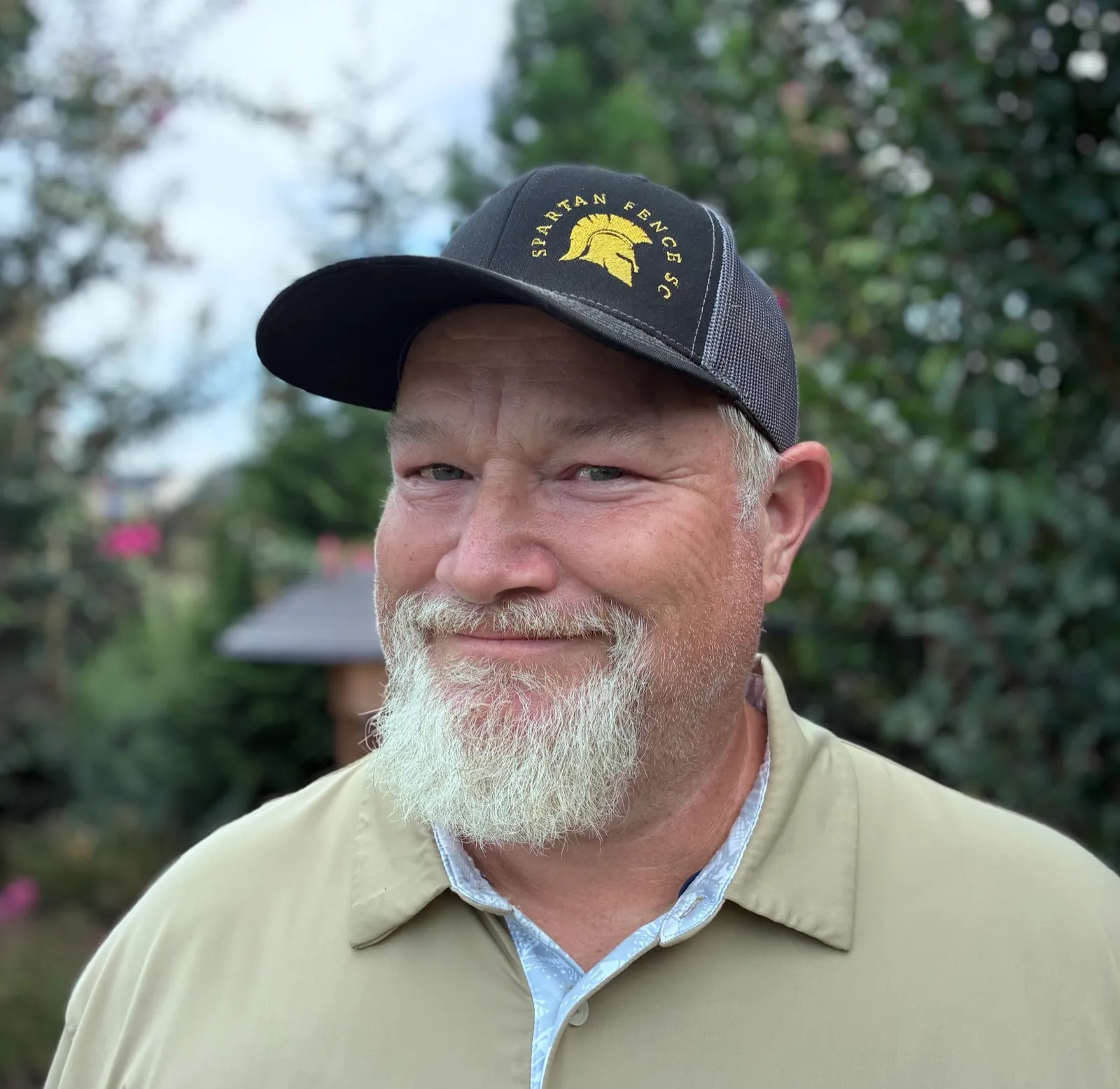Matt Jones, owner of Spartan Fence SC, smiling in a Spartan Fence hat