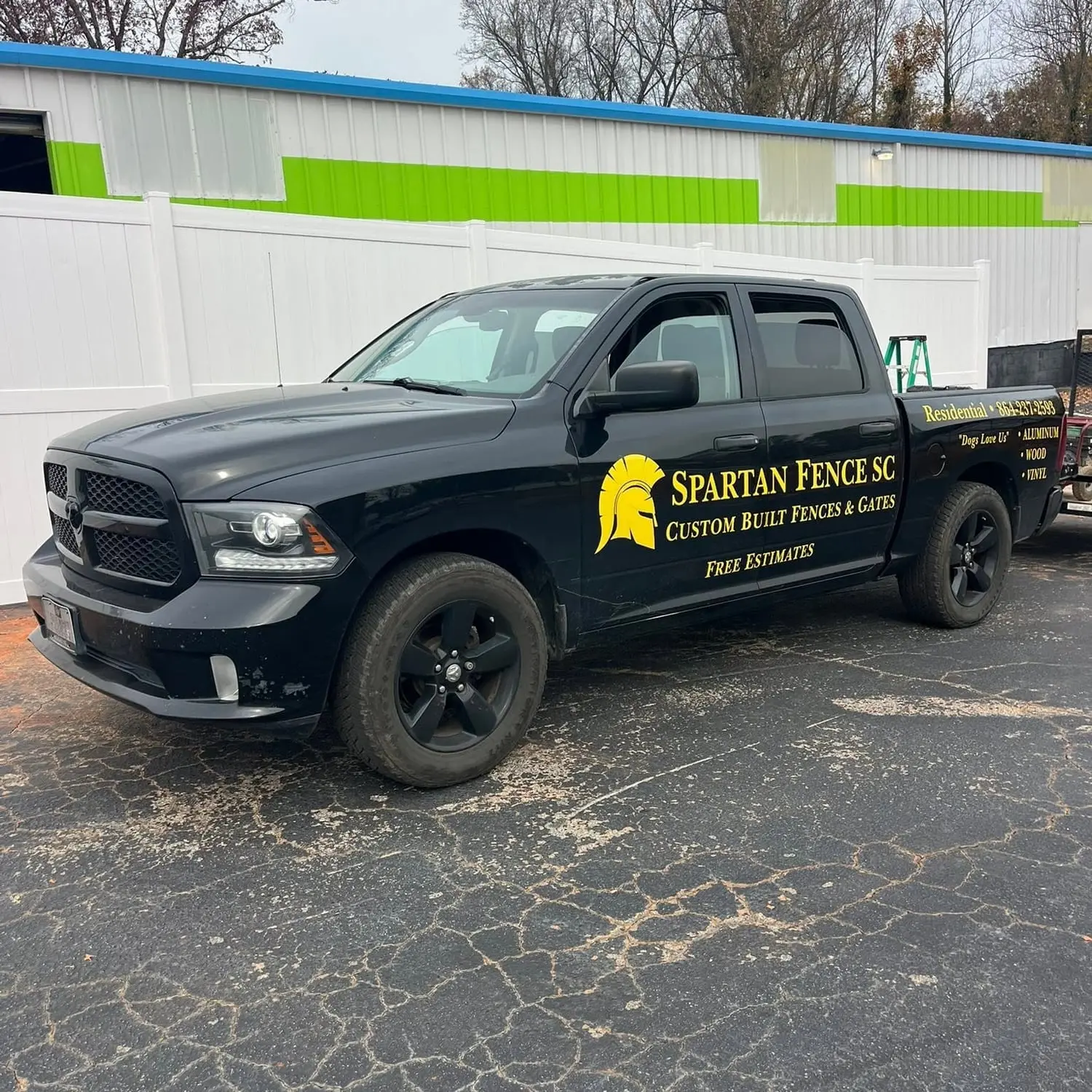 Spartan Fence SC branded work truck with the gold spartan helmet logo