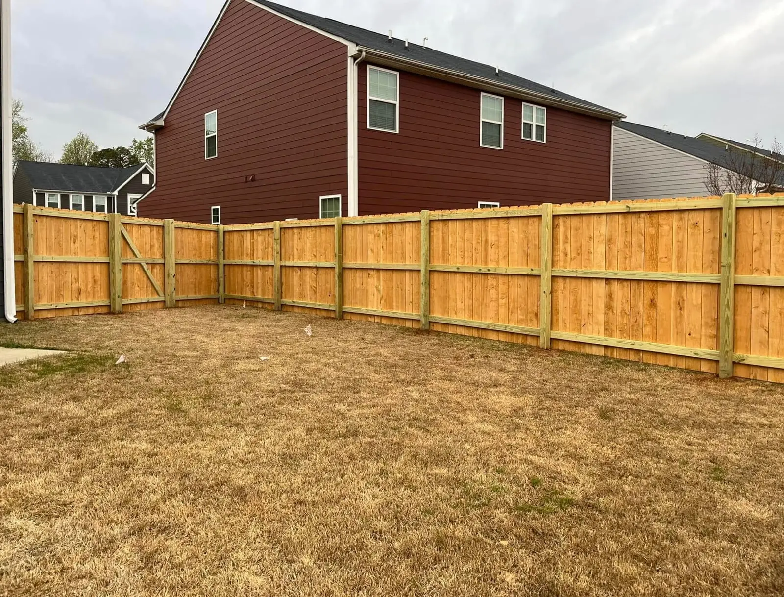 Wood privacy fence installed by Spartan Fence SC in a new backyard